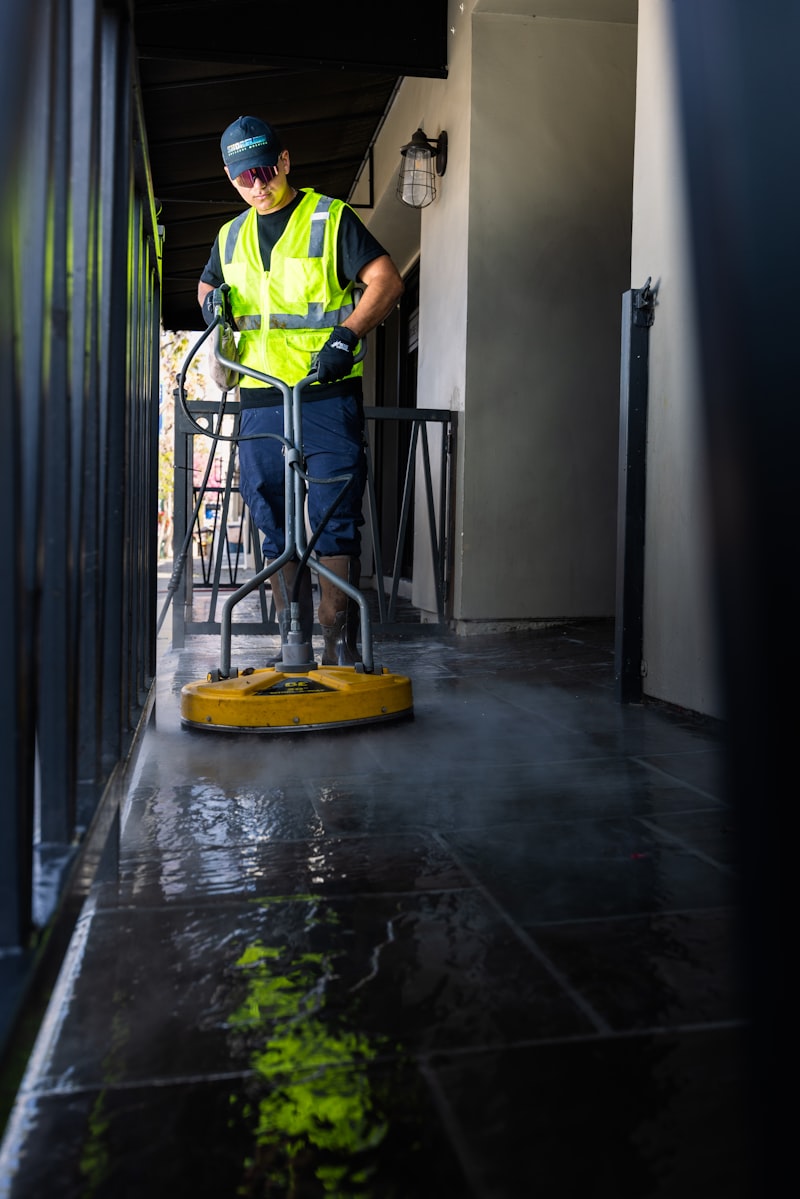 Professional softwash cleaning in action on court surface